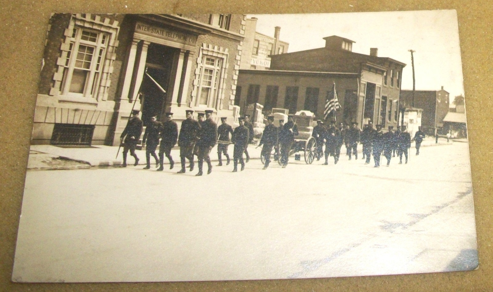1920's RPPC Postcard~Soldiers Walking Down Street Funeral?~Inter State Bldg S1