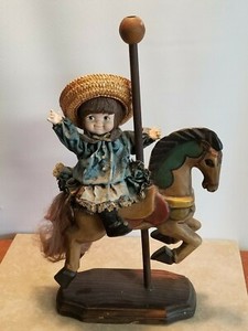 porcelain doll on carousel horse