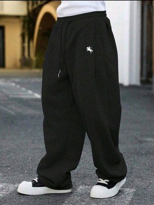 Pantalones de chándal sueltos de unicolor con cordón en la cintura y bolsillos.