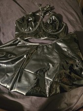 black patent leather-style lingerie set featuring a strappy bra top and a flared