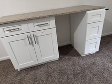 White cabinets with granite countertop.