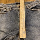 Blue denim Theory jeans, 30x33, with button fly closure, front pockets, and subtle faded detailing along the left leg.