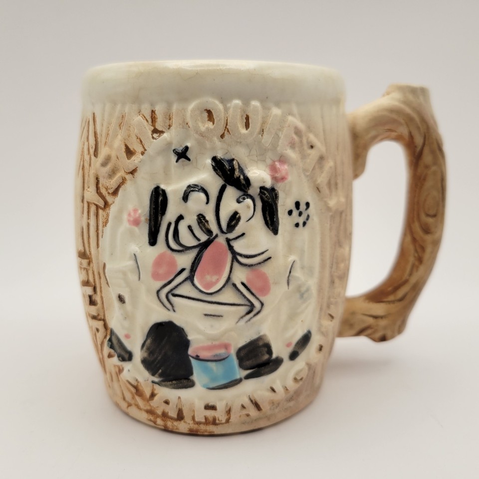 A 60s ceramic coffee mug with a 3D hangover face that literally begs you to 'Yell Quietly' — a genuinely funny, actually vintage gag gift.