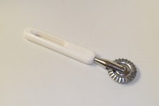 VINTAGE BONNY USA PIE TOOL WITH WHITE HANDLE.