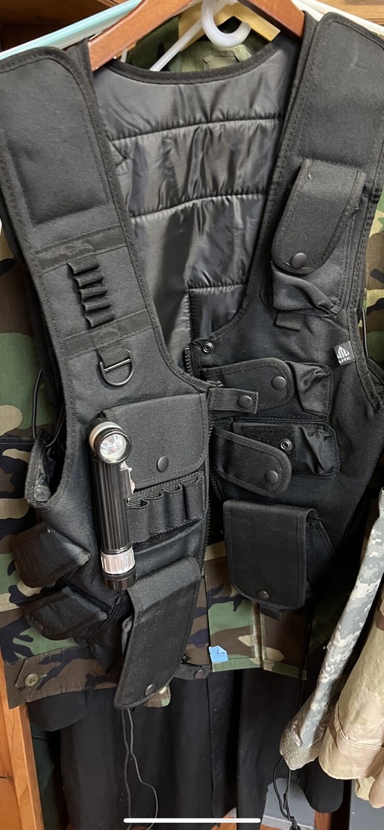 black tactiical vest with molle mag holders and map pocket