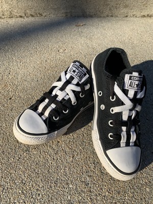 white low top converse with black stripe