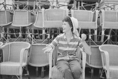 Italian actress Giorgia Moll sitting wicker chair smiling during 1- Old Photo