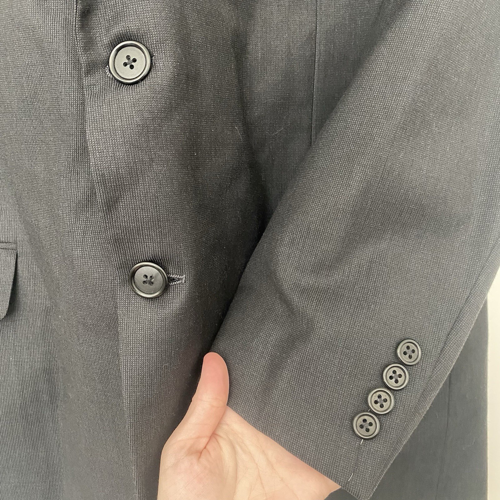 Gray Hickey Freeman men's 100% Super 130’s wool blazer with two-button front, notch lapel, and five-button cuffs on right sleeve.