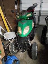 Green Three-Wheel Motor Scooter with Headlights and Rearview Mirrors
