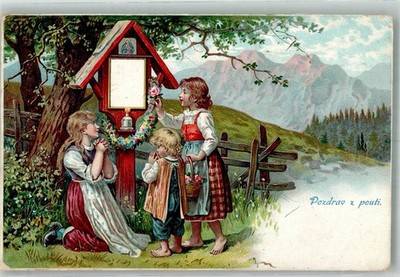 38164476 - Praying children with colorful flower garlands in front of a field cross