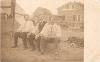 Three Handsome Men Sitting on Bench Outdoors 1910s RPPC Postcard Photo