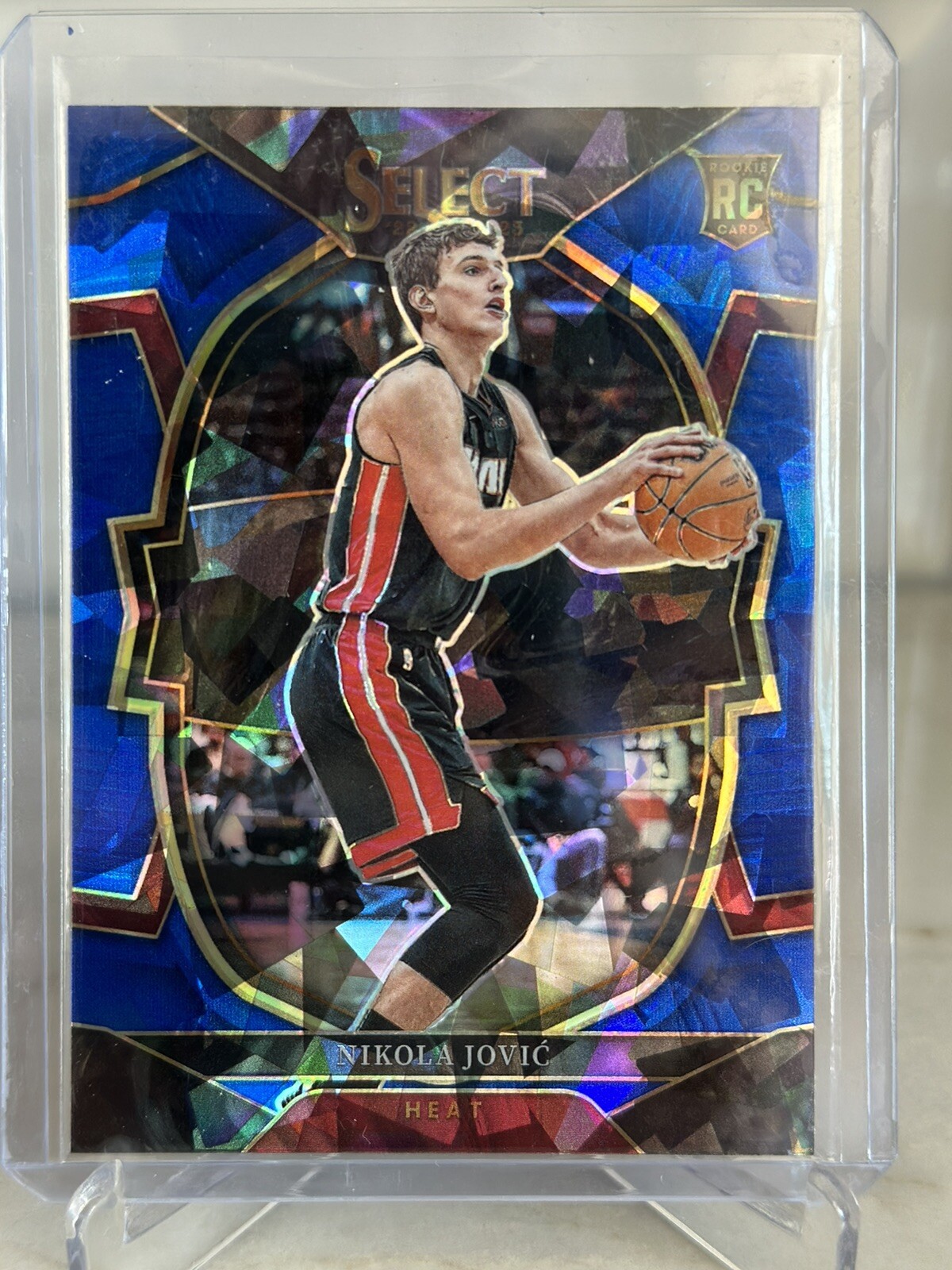 2022-23 Panini Select Nikola Jovic #91 Blue Cracked Ice Concourse Heat