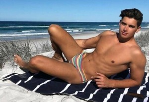 man in speedo on beach