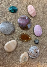 assorted semi-precious gemstone cabochons, which are polished Lot 10