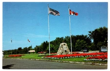 VINTAGE PHOTO PICTURE POSTCARD INTERNATIONAL PEACE GARDEN CAIRN AND FLAGS CARS
