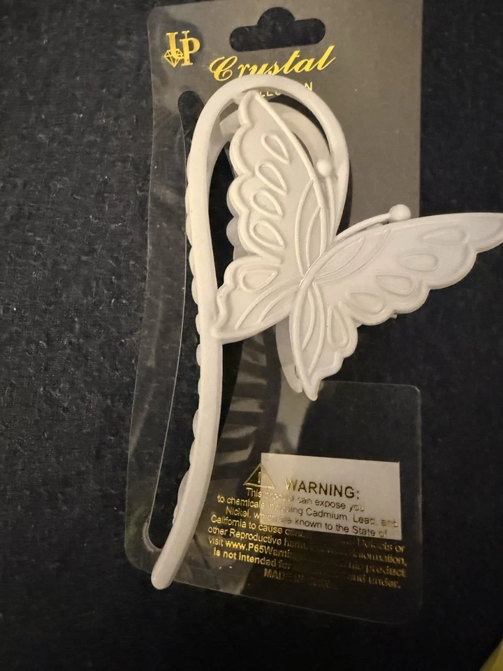 Garra de pelo de mariposa blanca de cristal Foto 2 de 4