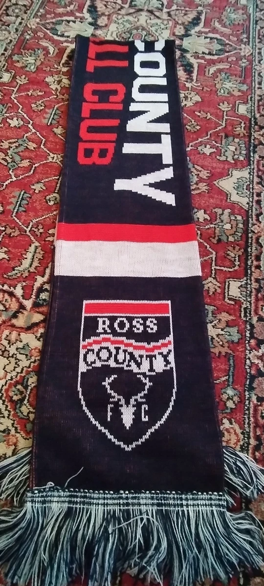 The official Aston Villa club badge on a scarf worn by a fan during