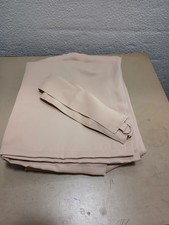 Beige curtains with tie backs.