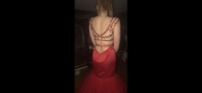 Sherri Hill Red Mermaid prom dress with beaded shoulders and back steps
