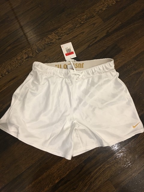 white nikes with gold swoosh