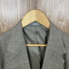 Haggar men's 42L green, black, and beige plaid coat with notch lapels, two buttons, and "Made in U.S.A." label.