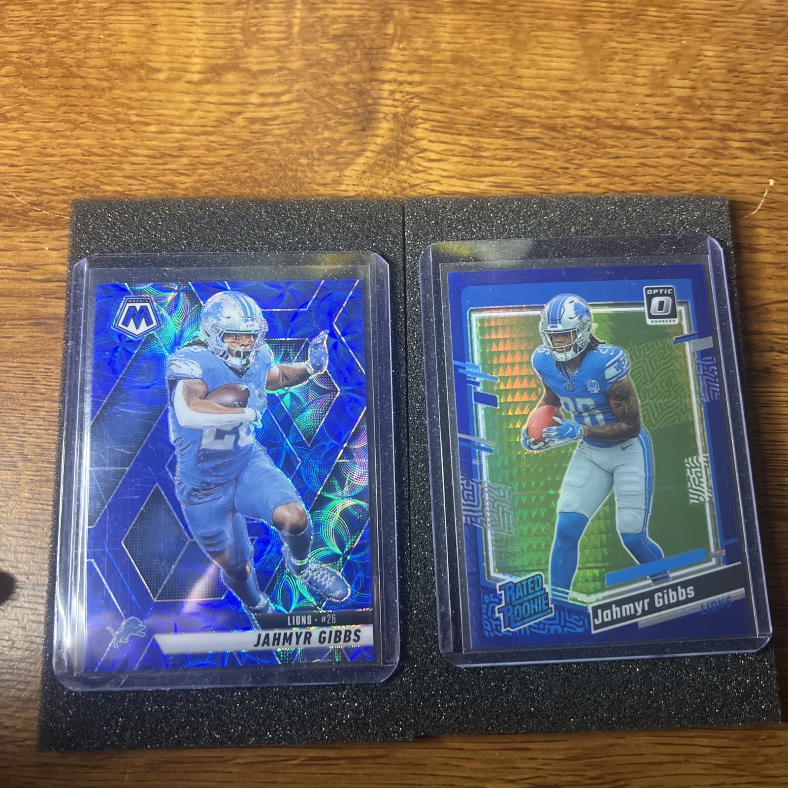 2025 Mosaic Jahmyr Gibbs 103 Blue Scope- 2023 Donruss Optic 236 Blue Hyper (RC)