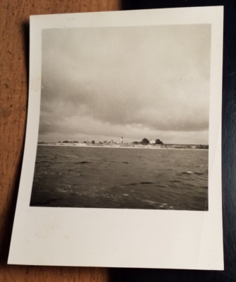 View from the water on site with lighthouse - circa 1950/60s / photo