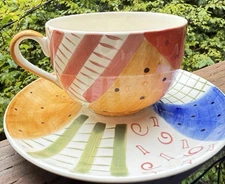 HAND PAINTED TEA CUP AND MATCHING SAUCER