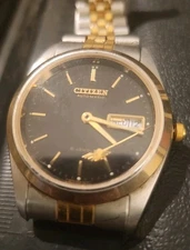vintage two-tone Citizen Eagle 7 Automatic Day-Date watch with a black dial