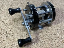 A Old Abu Ambassador 5500C Black   No.801100 Seal Emblem High Oil Nut With Econo