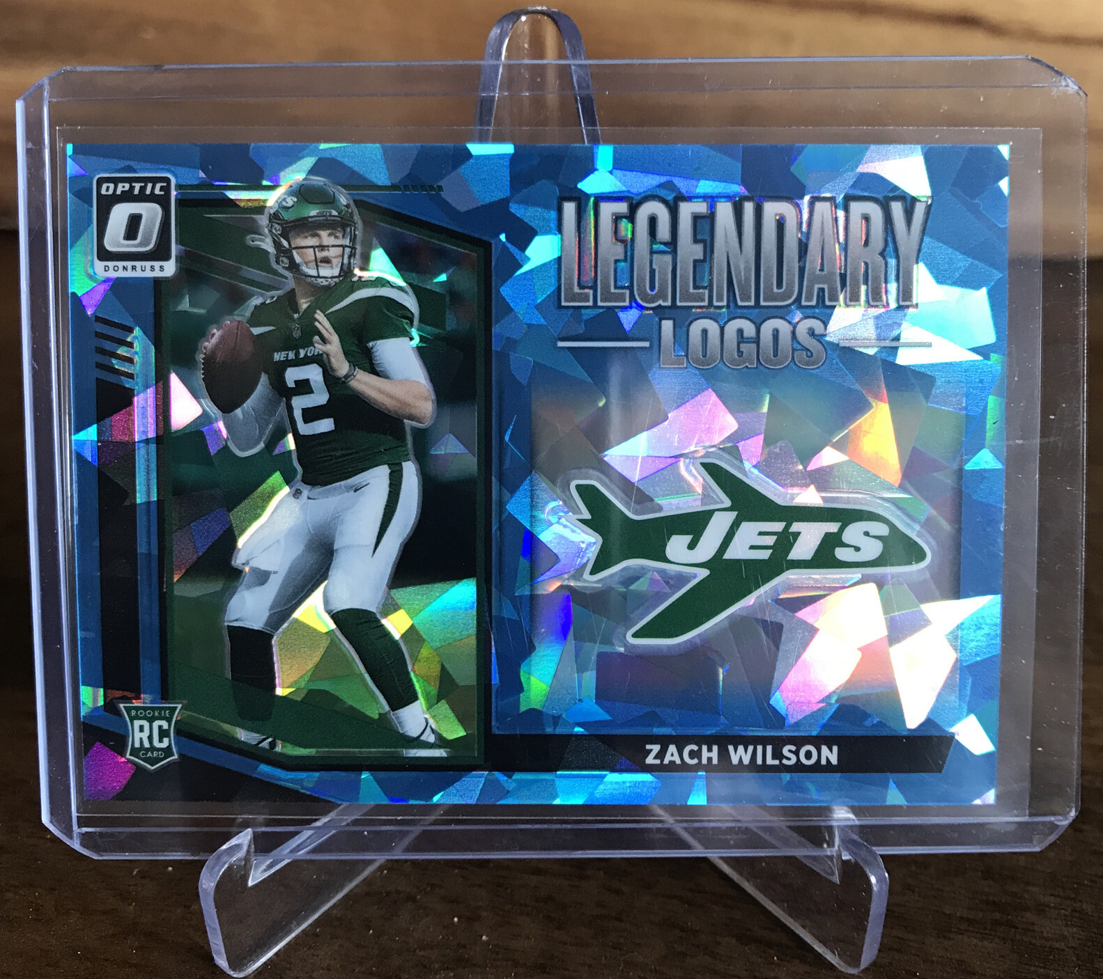 2021 Optic Football Zach Wilson Legendary Logos Blue Cracked Ice /15 SSP Jets