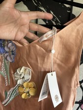 Tory Burch dress is crafted from a blush-colored satin and features   size 4