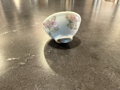 A hand-painted Kyo Ware ceramic tea bowl with floral motifs.