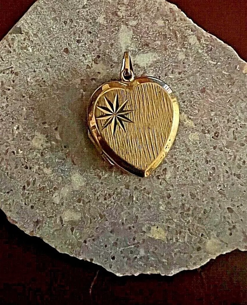 Sold at Auction: A 9K Yellow Gold Heart Locket Pendant on a 9K