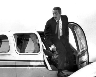 Paul Newman steps out of small airplane 1966 Harper 8x10 inch photo