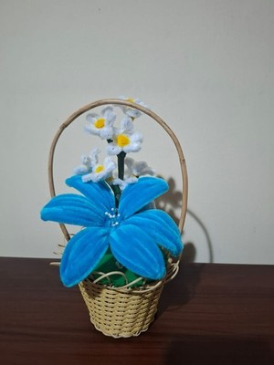 pipe cleaner blue lily flower in a cane basket