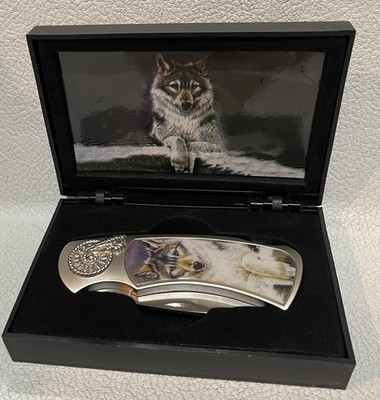Maxam Folding Knife with Wolf design on both sides.  Single blade.  In black box