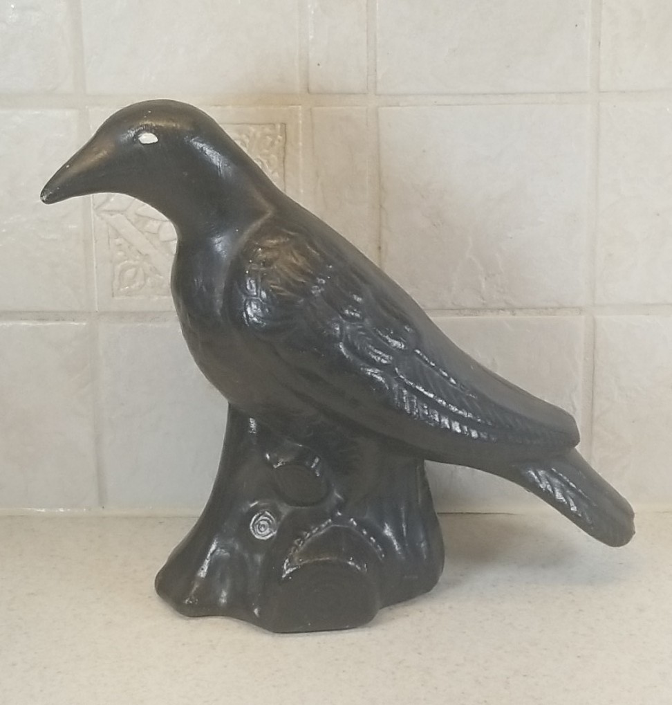 Vintage ceramic pottery raven figurine perched on a log base