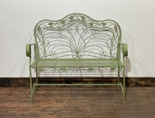 Ornate garden bench in green painted metal