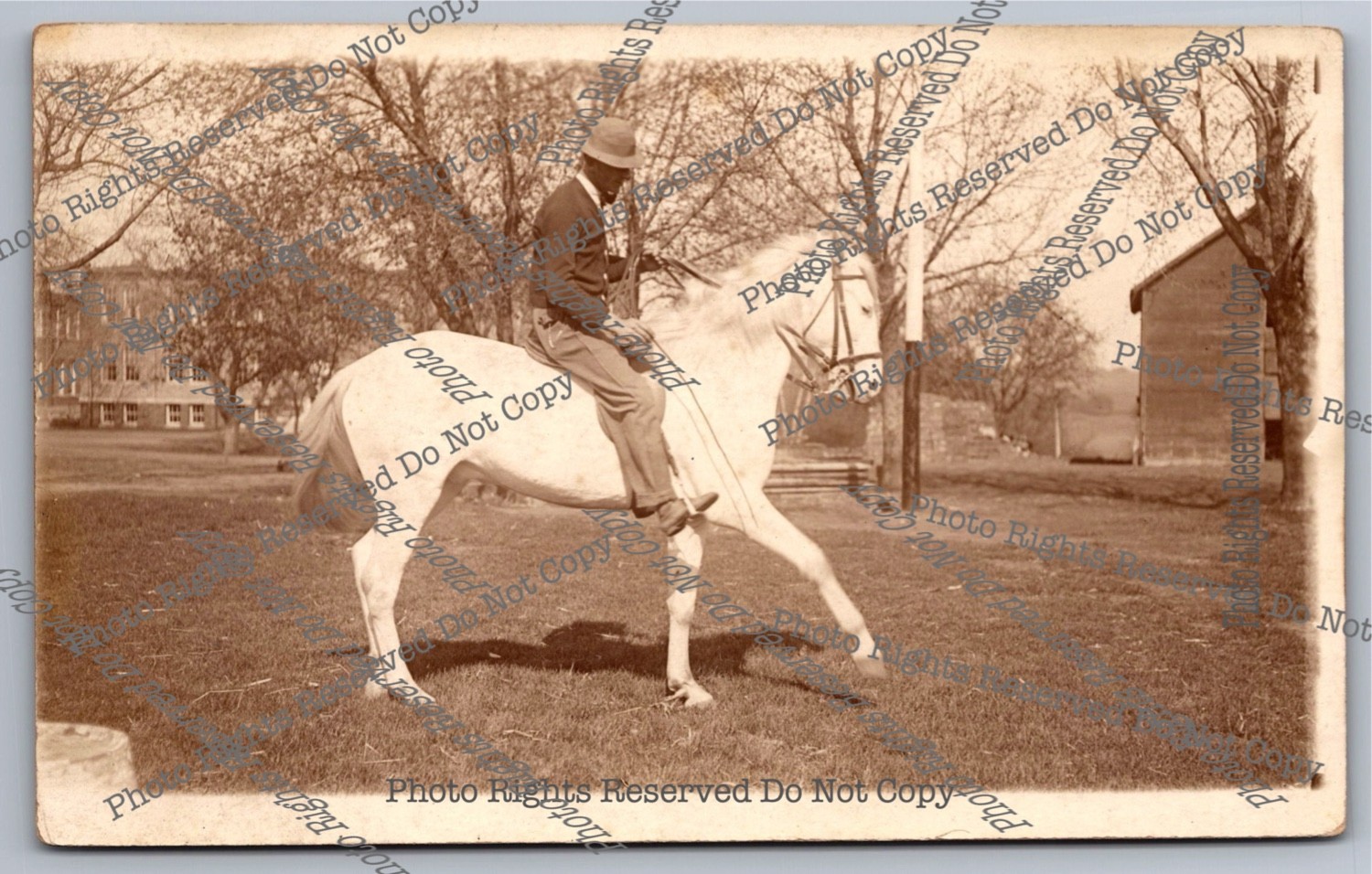 Antique RPPC man riding horse in park Real Photo Postcard 