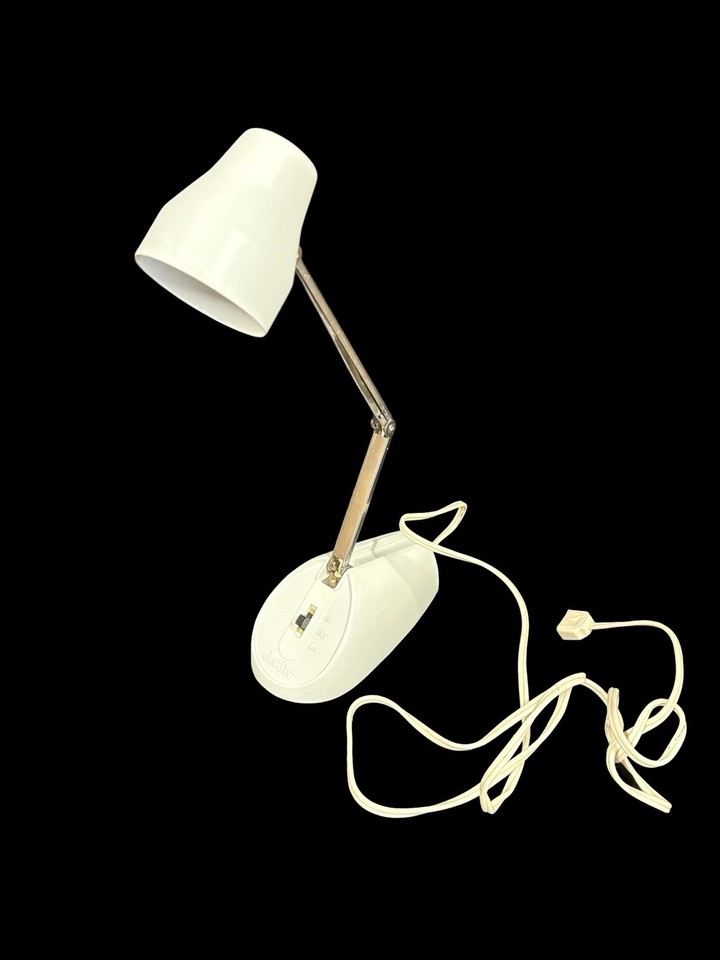 A tiny adjustable Jet Set desk lamp with full MCM styling — the kind of sleek, space-age miniature lamp that makes a desk look effortlessly cool.
