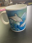 Colorful mug has dolphin and wave design.  "Gulf Shores Alabama" is on the mug. — photo 3