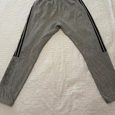Gray Adidas joggers with black stripes