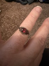 vintage-style sterling silver ring featuring a red gemstone