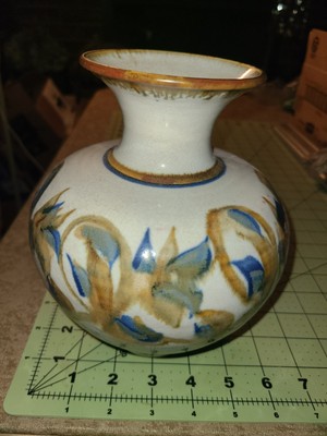 Signed art pottery bud vase featuring a round shape and tulip flower design. 