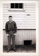 WW2 Photo of Soldier Running Past Barracks with Cars in Background