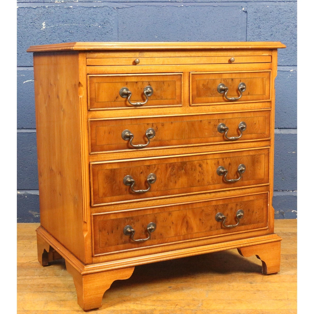 A Georgian Style Yew Wood Bachelors Chest of Drawers with Leather Brushing Slide