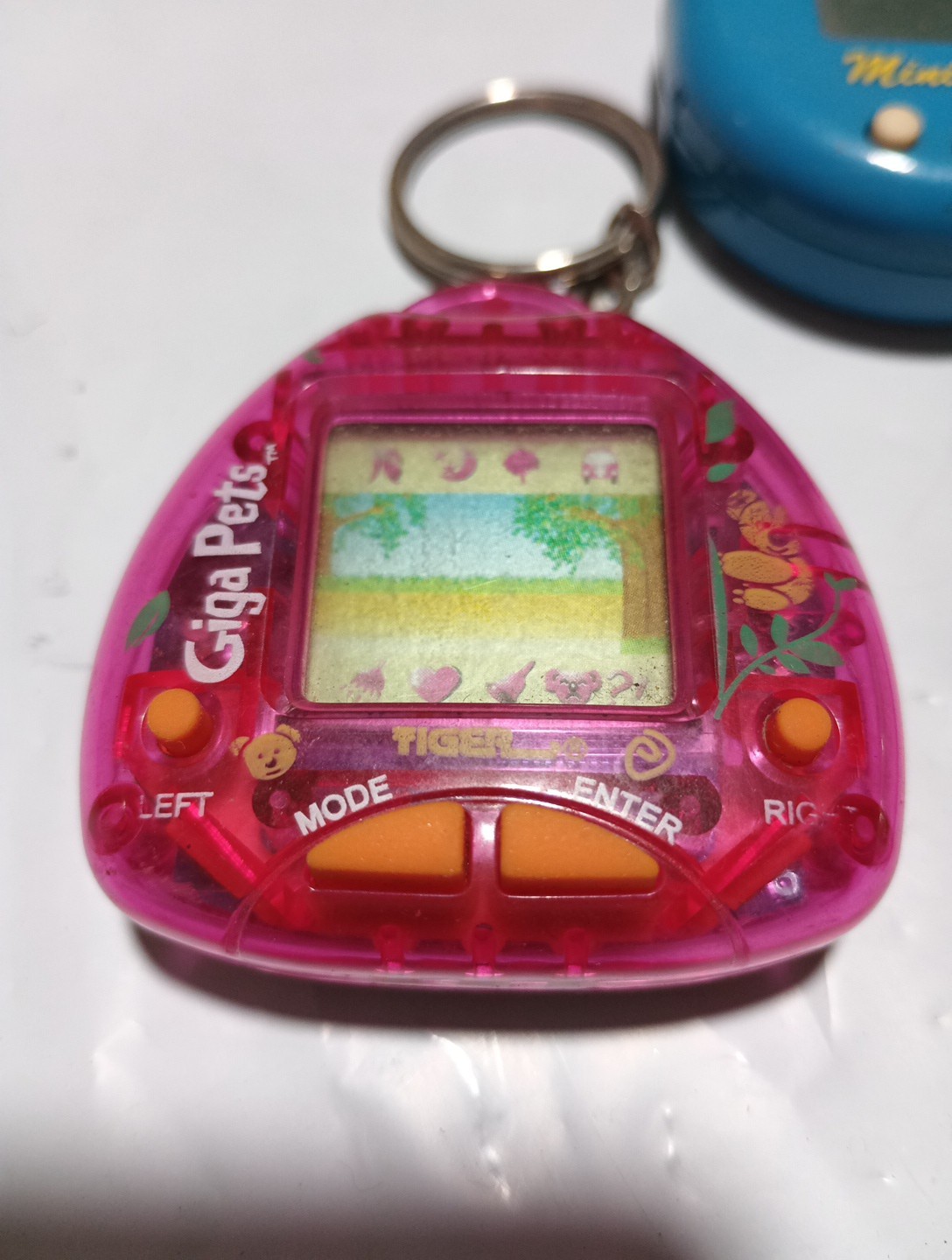 two giga pets keychain games and one 8-in- 1 mini pets 