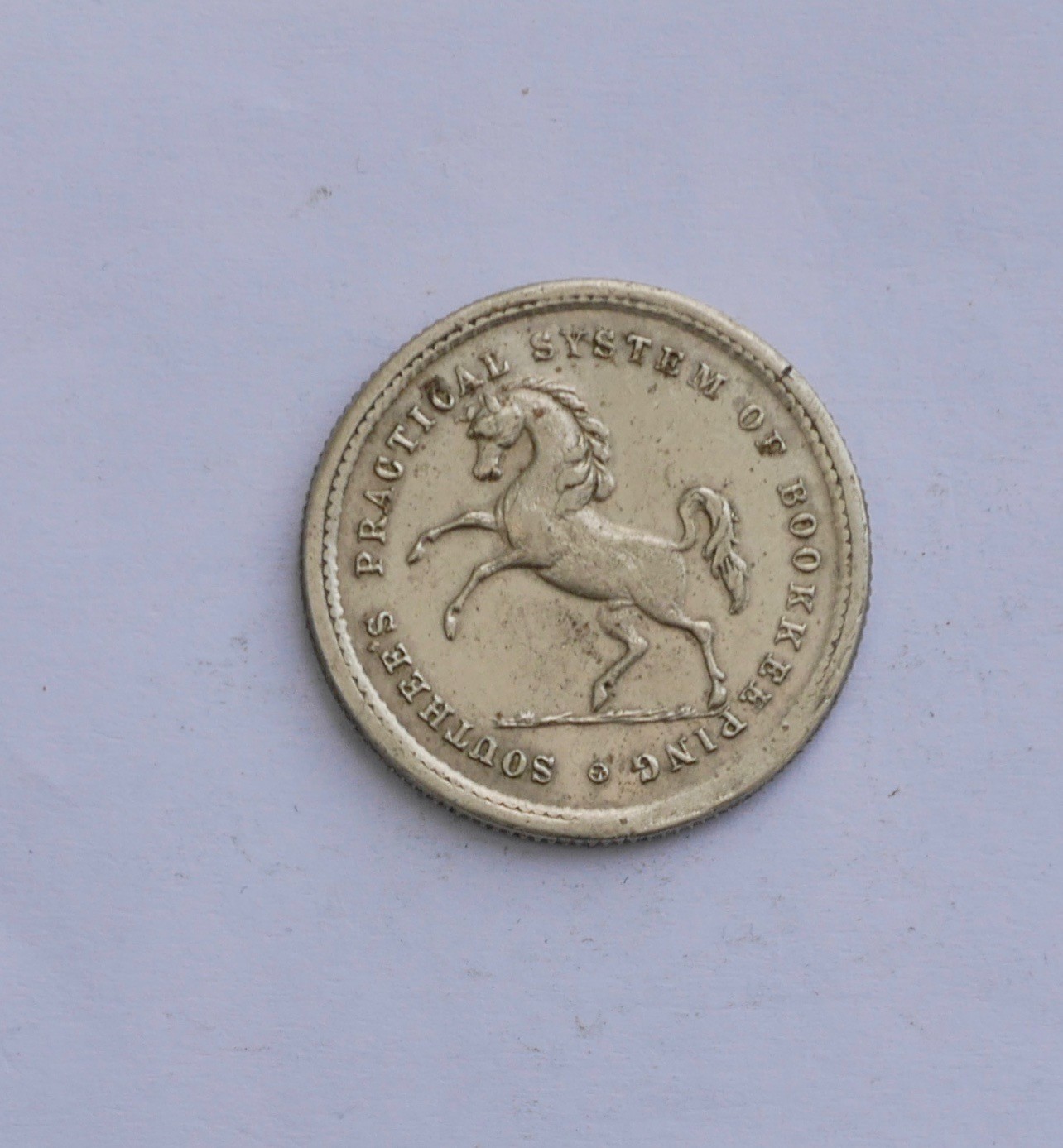 "SOUTHEE'S PRACTICAL SYSTEM OF BOOKKEEPING" SHILLING TOKEN, PRANCING HORSE