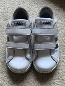 white tennis shoes with black stripes